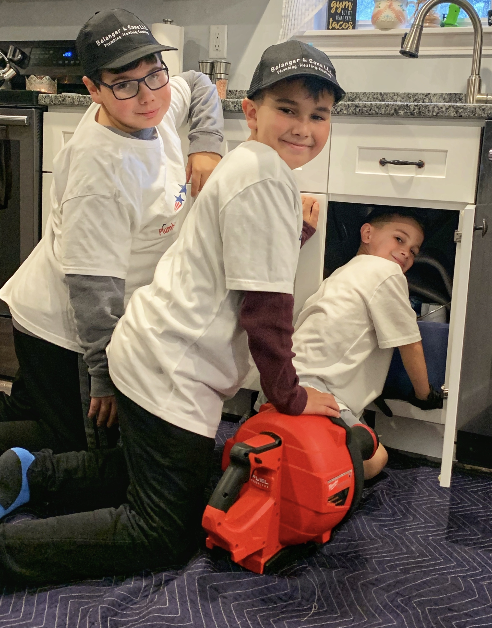 Kids fixing a sink at Belanger and Sons Plumbing and Heating.